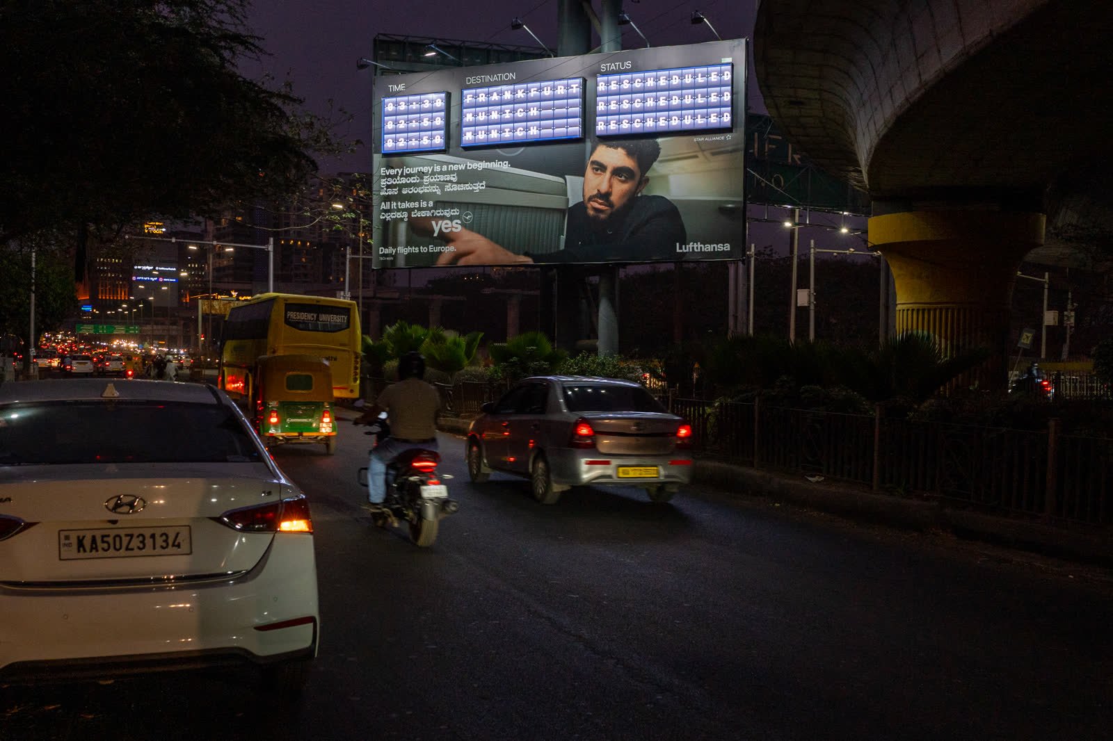 Large roadside hoarding at Hebbal in evening traffic